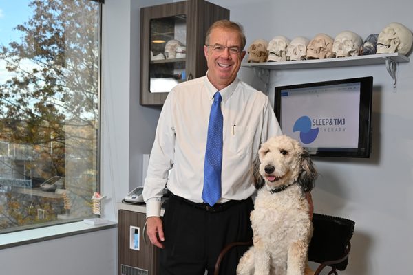 Dr Brown and his dog, Penny sitting for a photo shoot with the Washingtonian.