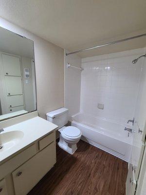 Spacious bathrooms with linen closet and a laundry drop.