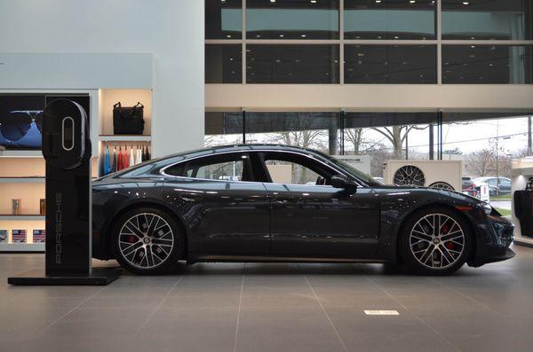 The Porsche Taycan charging at a Porsche dealership near Columbus, Ohio