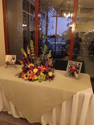 Table set up with pictures and urn for ceremony.