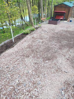 New flower garden with freshly laid brown mulch along driveway