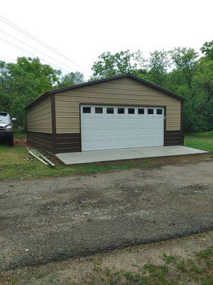 24x30 two toned garage with 16' overhead door, service door, and 6' roll up door.