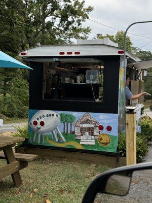 The outside of the coffee shop featuring hand painted local imagery