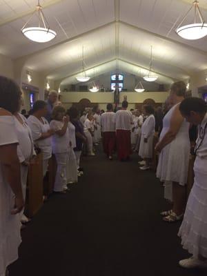 Catholic daughters of the americas line the main aisle for a funeral of a favorite daughter.