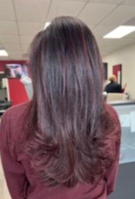 This long layer haircut with a red balayage was done by Maria.