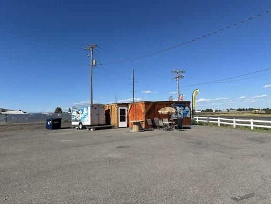 Outside. Just a little structure pieced together in a parking lot to make BOMB tacos! Nothing else needed.