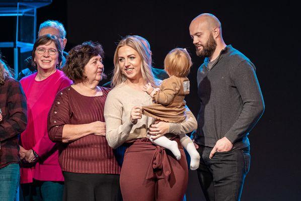 Family on stage during child dedications at Lifepoint - Delaware Campus.