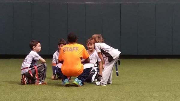 The Bass kids playing flag football for Hi-Five