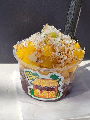 Acai, pineapples, mangos, banana, honey, granola, and coconut flakes