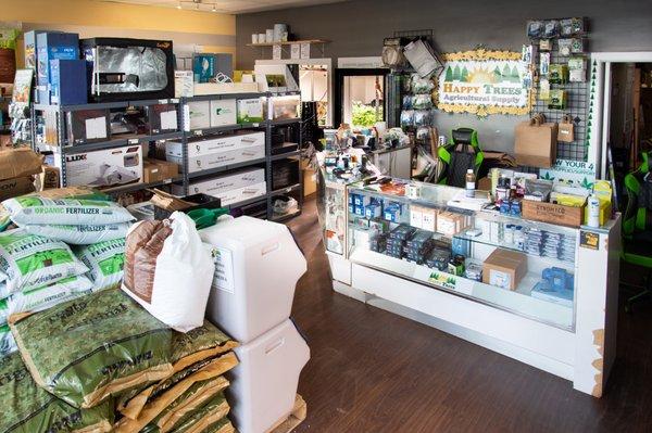 Front counter in Happy Trees with agricultural supplies for sale on display.