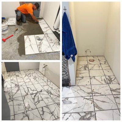 installation on marble tile flooring in bathroom with two alcoves on either side.