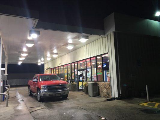 Truck parked at the front of the store at night