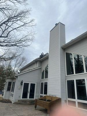 Worker waving from the roof at the camera