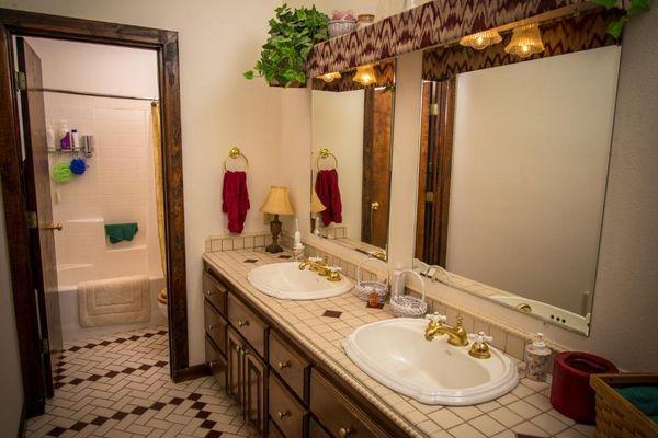 Upstairs shared bathroom. Each room has their own sink/towel area.