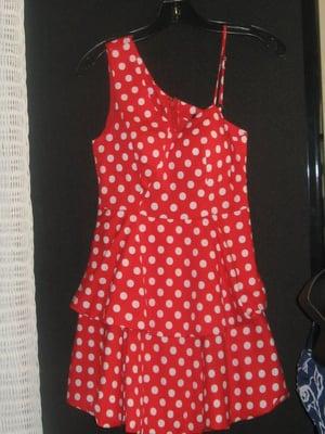 A cute layered red and white polka dot dress with one shoulder and the other a skinny strap