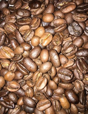 Fresh roasted coffee. In this case, roasted to city roast  (light to medium) while changing the speed to push thru unique flavor.