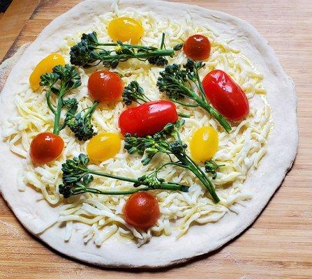 Pizza blanco with heirloom tomatoes and broccolini