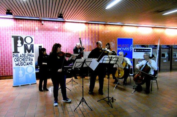 Philadelphia Orchestra musicians playing in the station