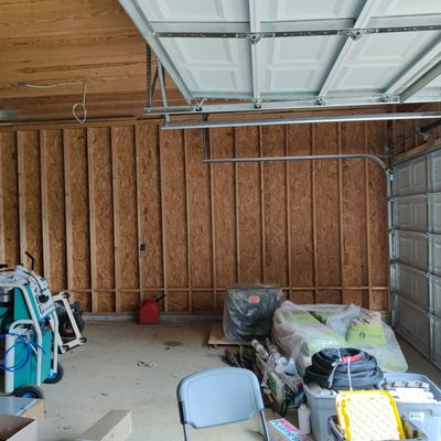 The garage walls that are not considered the exterior walls of the house.