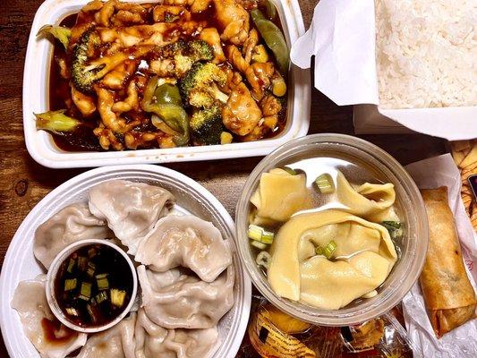 Meal spread chicken w/ garlic sauce, wonton & hot n sour soups and dumplings