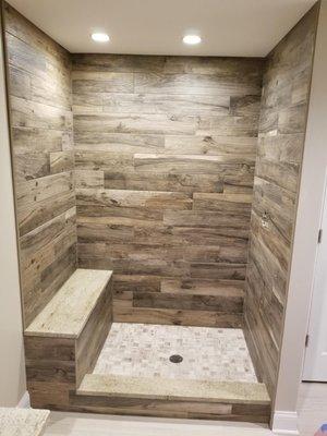 Custom shower pan / w seat, wood plank tiles on walls