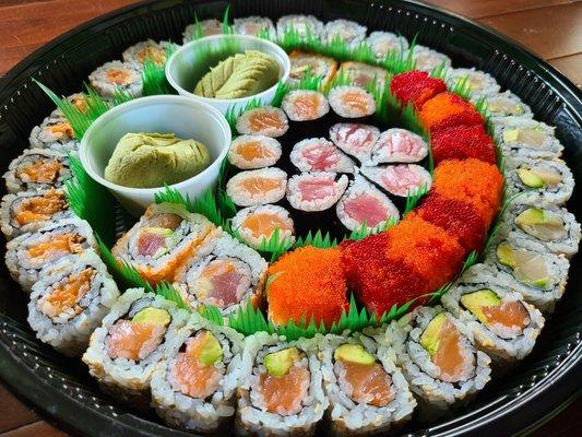 Party platter 1/2. Tuna roll, salmon roll, salmon w/avocado, spicy crunchy salmon roll, tuna w/avocado, volcano roll, and yellowtail w/avo.