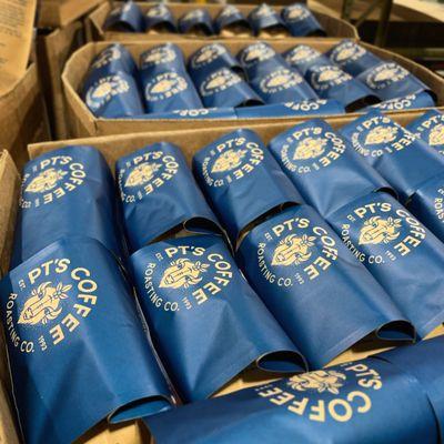 Bags of freshly roasted coffee being prepared for shipment at the PT's warehouse.