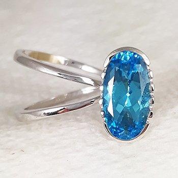 Lady's 18k white gold set with an oval fantasy cut swiss blue topaz.