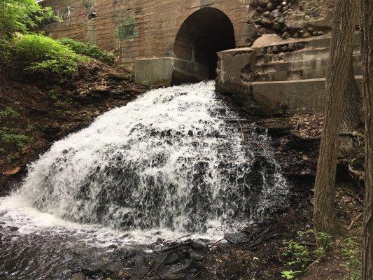 A waterfall under the city street.