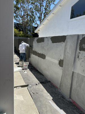 Smooth stucco finish on block wall