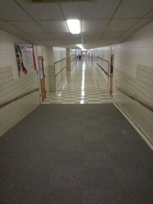 carpet and vct  tile in a high school corridor