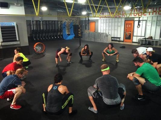 Stretching before Iron Tribe Fitness workout class