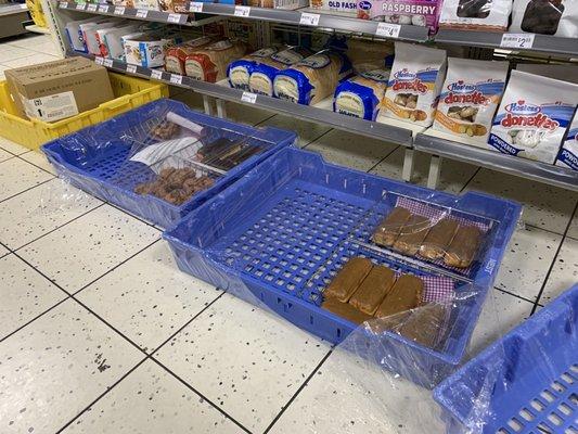 Donuts splayed centimeters from the dirty floor as customers reach over and kick dirt around them. Over 10 minutes in store