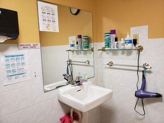 Spotlessly clean bathroom with lots of covid-19 safety reminders