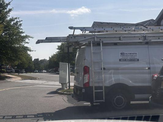 Company doing the work and their ladders are blocking the roadway. Safety issue, it's apparent they do not care.