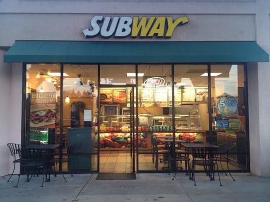 Store front with outdoor seating.