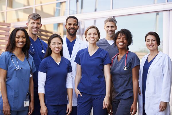 A team of doctors being photographed at the hospital.