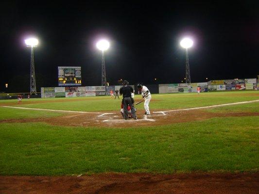 The view (there is a screen to protect from stray throws/foul balls) from behind home plate in the front row.