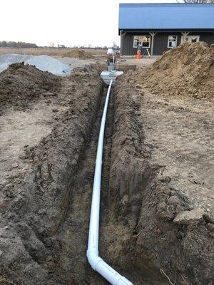 Lamb Excavating runs a septic line from a newly built home.