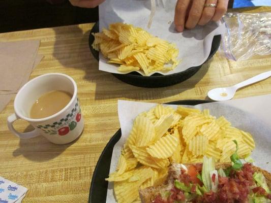 BLT sandwich served with chips