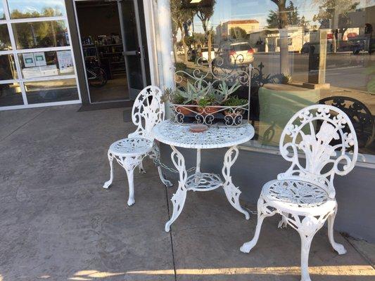 Outside the thrift store and a salon on Broadway. Many people in town have painted iron bistro sets.