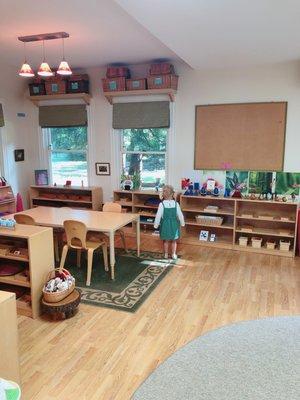 Exploring the beautiful, sun-filled classroom organized meticulously to display colorful, exciting works at children's eye-level.