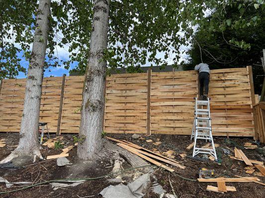 Unique 8' tall basket weave horizontal on an extreme slope! Perfect for that extra bit of privacy