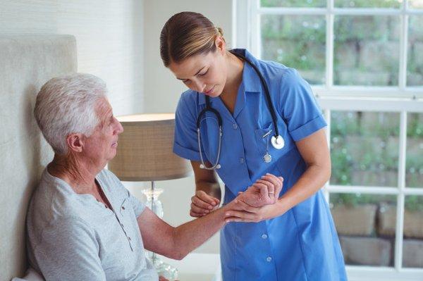 Nurse Examining Patient in Home