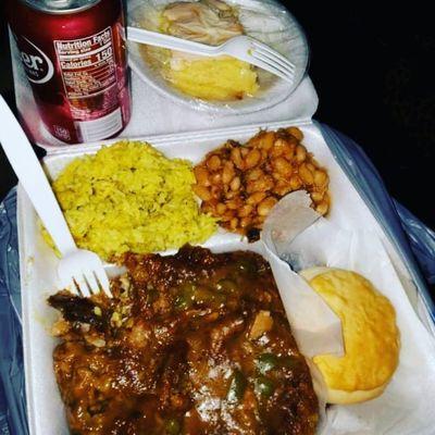 Fried then smothered porkchop with yellow rice and navy beans