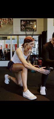 Laura working with a client at the gym.