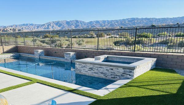 Pool and spa with water features! We love the hardscape design as well! The plants are next!