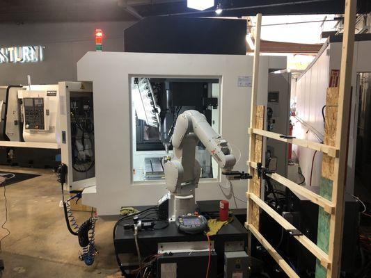 Robot interfaced to a CNC machine. Used for parts placement and removal.