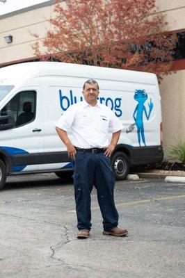 Service tech in front of a bluefrog Plumbing + Drain service van ready to install water filtration systems in North Dallas ho...