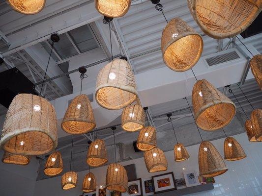 Love the contrast of the concrete walls and hanging lamps.